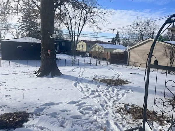 a view of a yard covered with snow