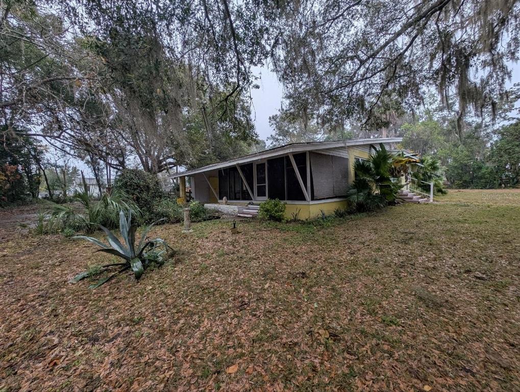 2304 Vine Street Leesburg, FL 34748 - Photo 2 of 25 a view of a house with backyard and trees