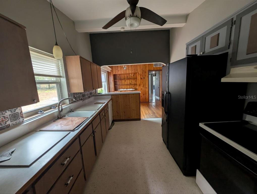 2304 Vine Street Leesburg, FL 34748 - Photo 7 of 25 a kitchen with granite countertop stainless steel appliances a sink stove and refrigerator