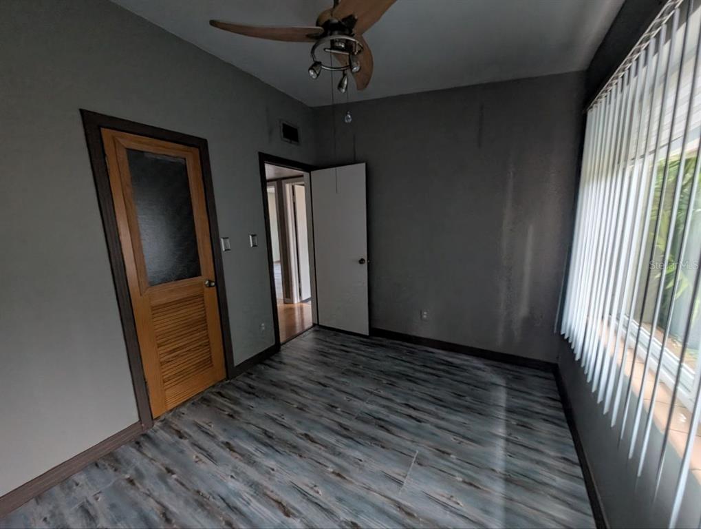 2304 Vine Street Leesburg, FL 34748 - Photo 10 of 25 a view of a hallway with wooden floor and stairs