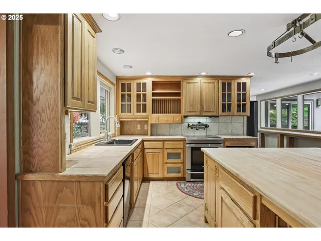 a kitchen with a sink stove and cabinets