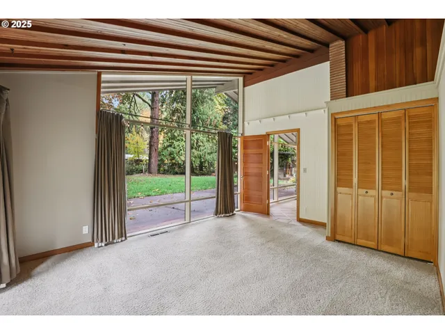 a view of empty room with floor to ceiling window