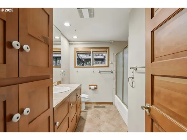 a bathroom with a double vanity sink a mirror and a shower