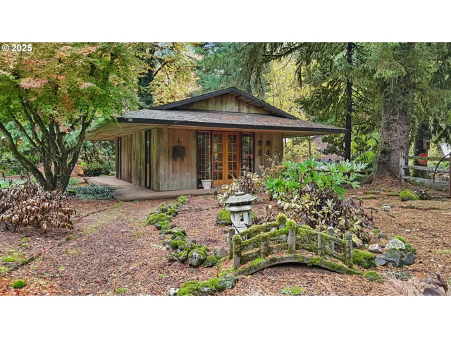 a view of a house with a small yard and floor to ceiling window