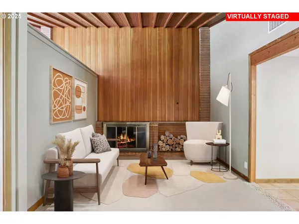 a living room with furniture and a painting on the wall