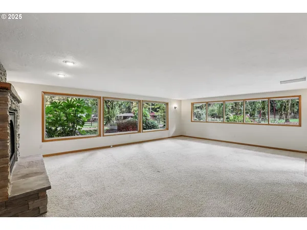 a view of a big room with wooden floor and garden