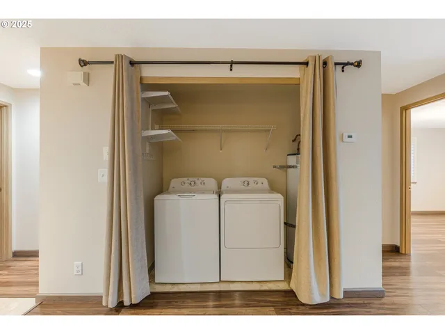 a utility room with cabinets and washer