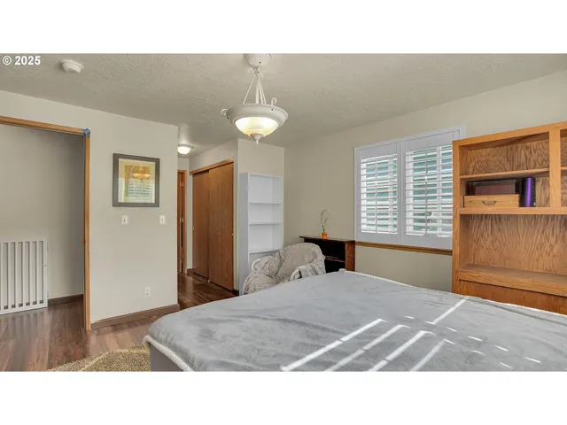 a living room with a bed furniture and a window