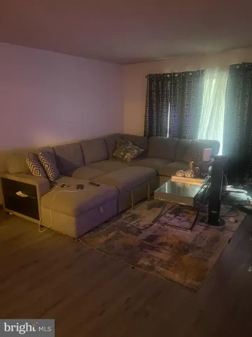 a living room with furniture and a lamp