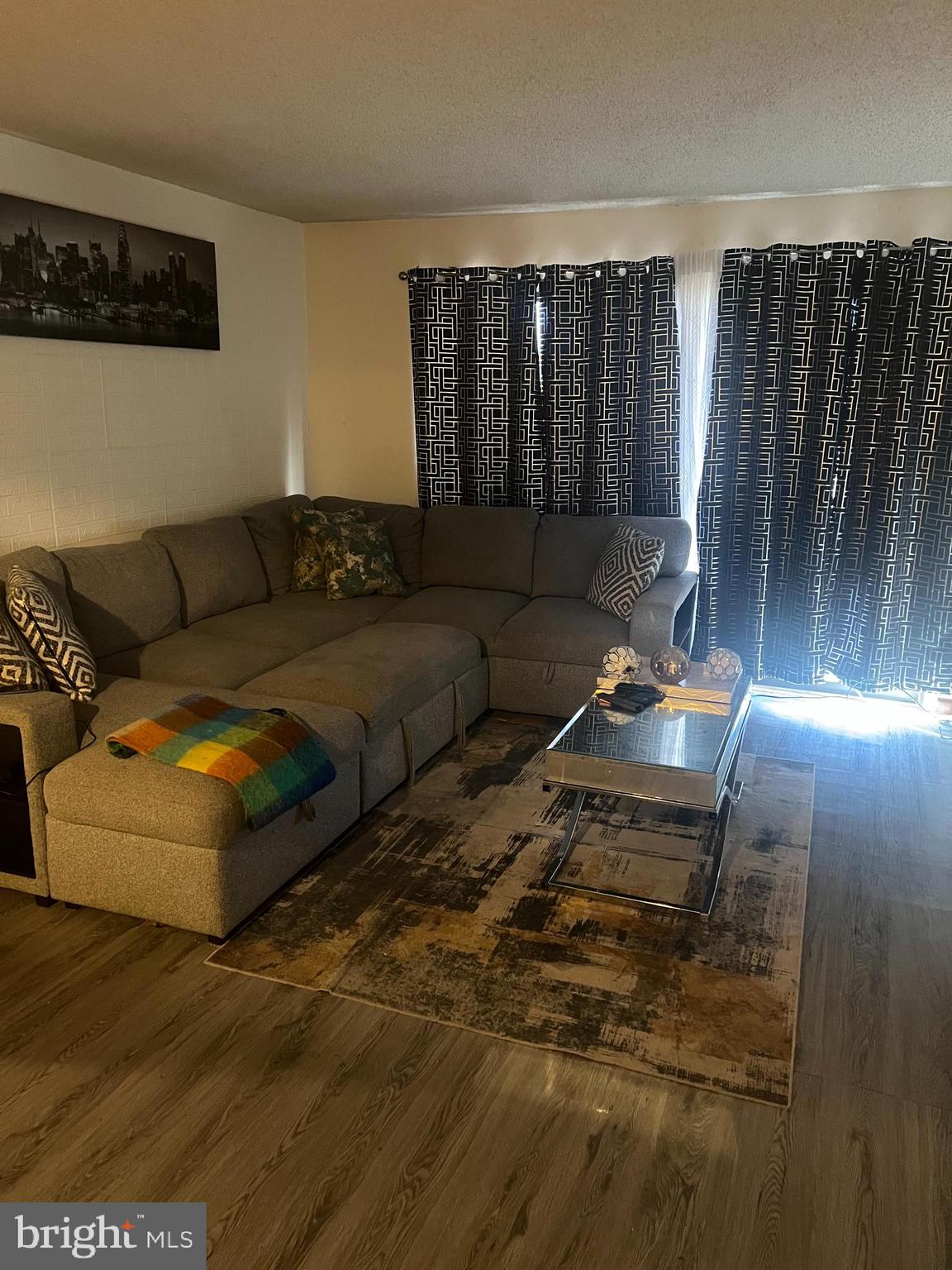 229 Colonial Court Absecon, NJ 08205 - Photo 6 of 7 a living room with furniture and wooden floor