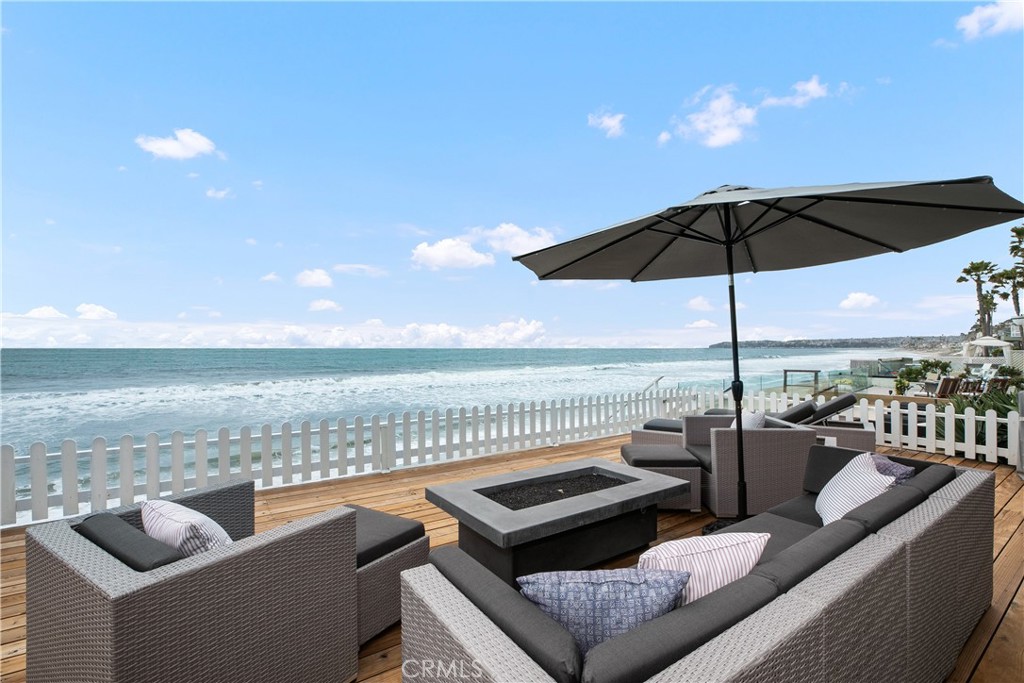 35565 Beach Road Dana Point, CA 92624 - Photo 2 of 2 a view of a roof deck with couches under an umbrella