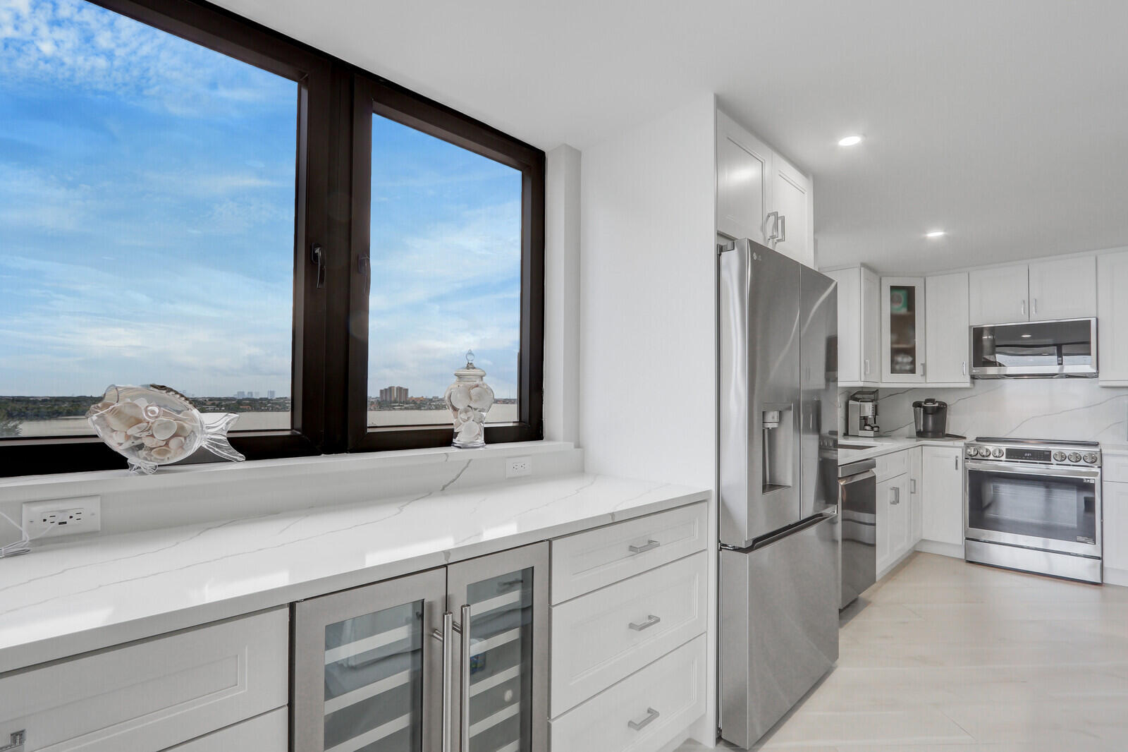 5380 North Ocean Drive, Unit 9A Singer Island, FL 33404 - Photo 12 of 38 a kitchen with stainless steel appliances kitchen island granite countertop a refrigerator and cabinets