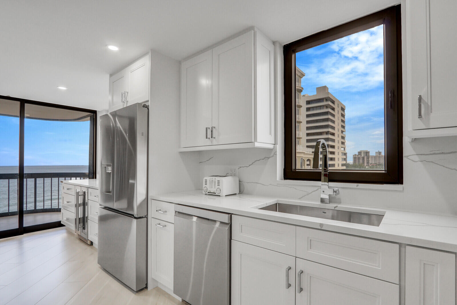 5380 North Ocean Drive, Unit 9A Singer Island, FL 33404 - Photo 15 of 38 a bathroom with a sink and a large mirror