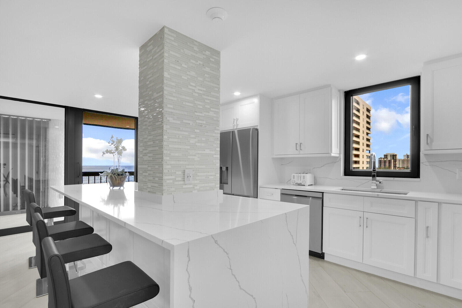 5380 North Ocean Drive, Unit 9A Singer Island, FL 33404 - Photo 16 of 38 a kitchen with stainless steel appliances kitchen island sink refrigerator and stove