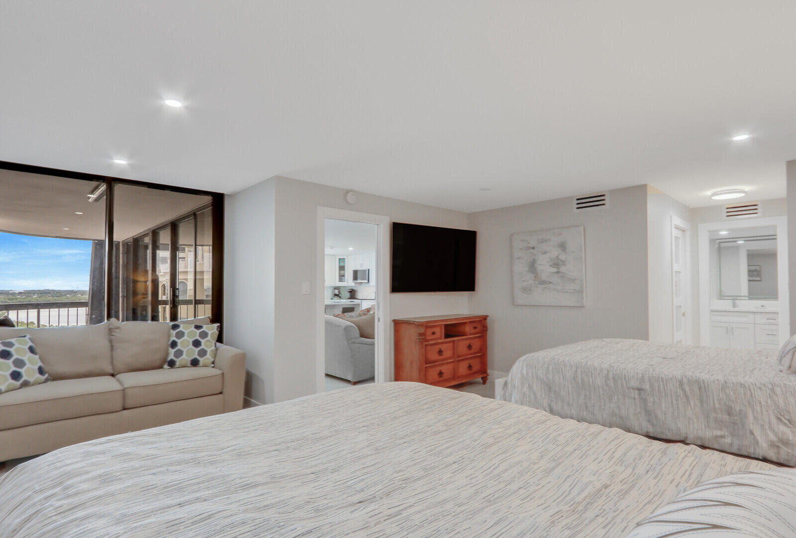 5380 North Ocean Drive, Unit 9A Singer Island, FL 33404 - Photo 24 of 38 a bedroom with a bed and a flat screen tv