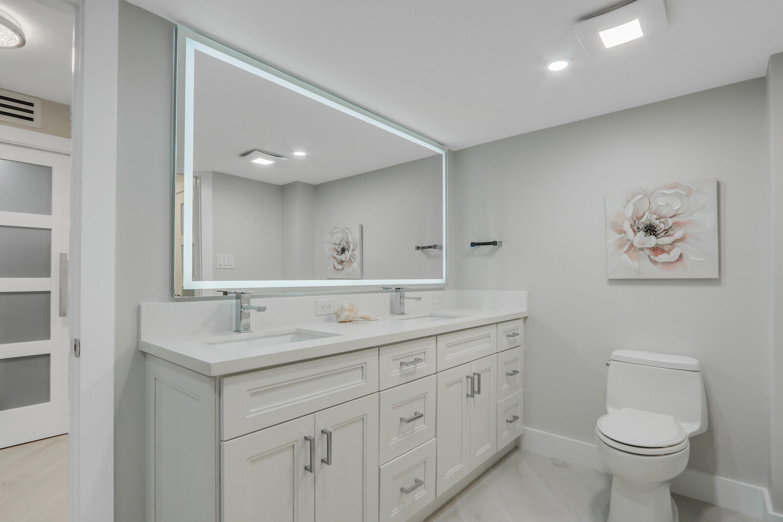 5380 North Ocean Drive, Unit 9A Singer Island, FL 33404 - Photo 25 of 38 a bathroom with a toilet sink and mirror