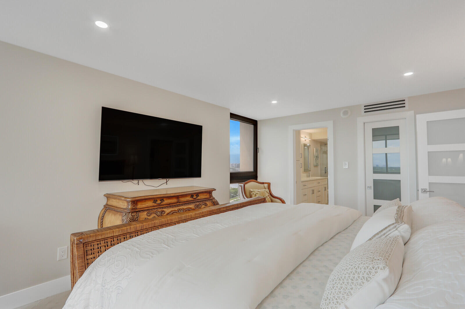 5380 North Ocean Drive, Unit 9A Singer Island, FL 33404 - Photo 29 of 38 a bedroom with a bed and a flat screen tv