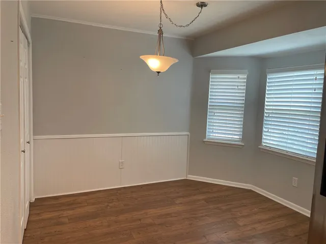 a view of a room with wooden floor and windows