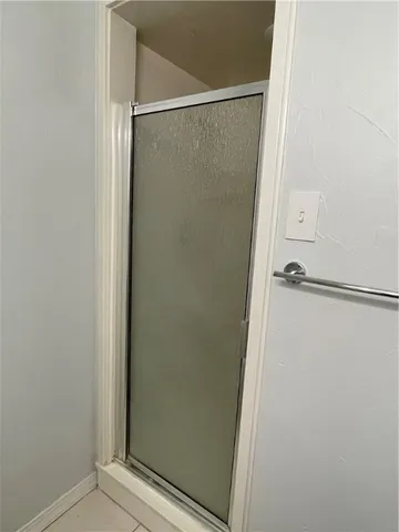 a bathroom with a glass shower door