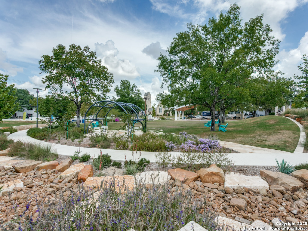 112 Ruelle Lane, Unit 112 San Antonio, TX 78209 - Photo 12 of 16 a view of a water pond with green yard
