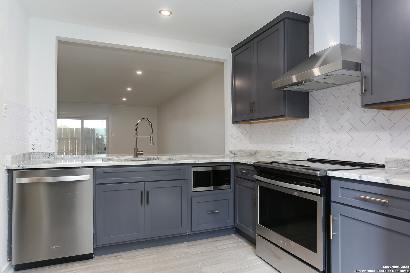 112 Ruelle Lane, Unit 112 San Antonio, TX 78209 - Photo 4 of 16 a kitchen with a stove sink and cabinets