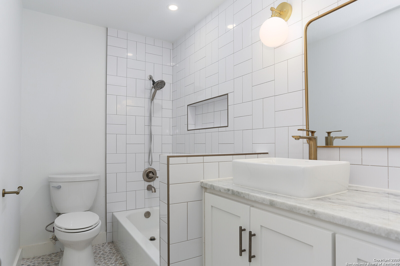 112 Ruelle Lane, Unit 112 San Antonio, TX 78209 - Photo 6 of 16 a bathroom with a granite countertop sink a toilet and shower