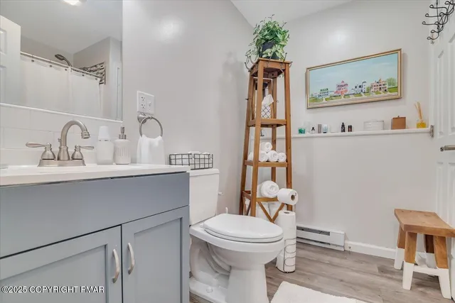 a bathroom with a toilet a sink and a mirror