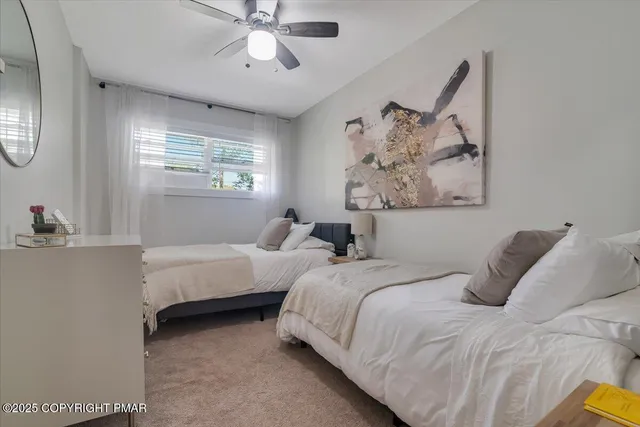 a bedroom with two beds and a window
