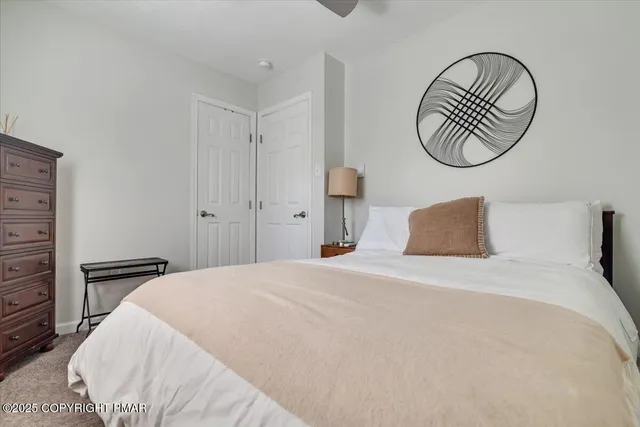 a bedroom with a bed and a chair