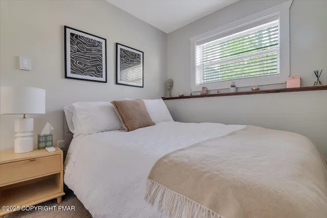 a bedroom with bed and window