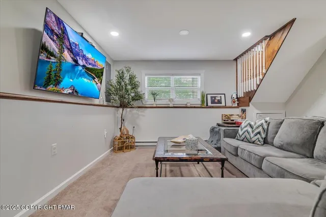 a living room with furniture and painting on the wall