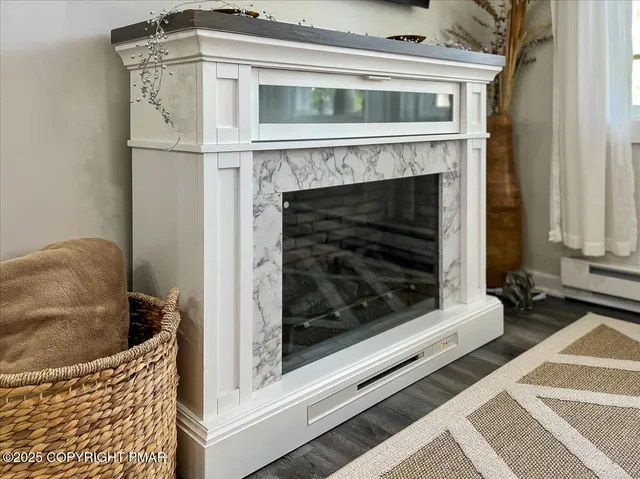 a living room with a fireplace and a rug