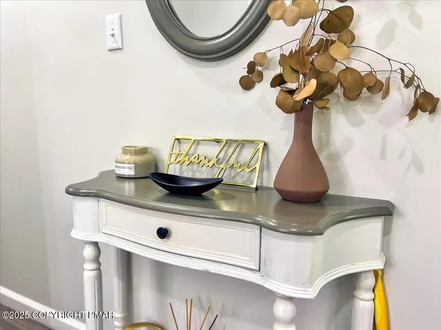 a table with a vase and flowers on it