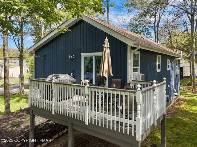 a view of a house with a small yard and wooden floor and fence