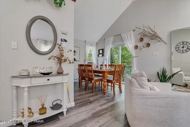 a living room with furniture and a mirror