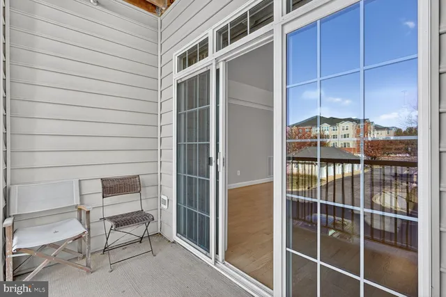 a backyard of a house with a table and chairs