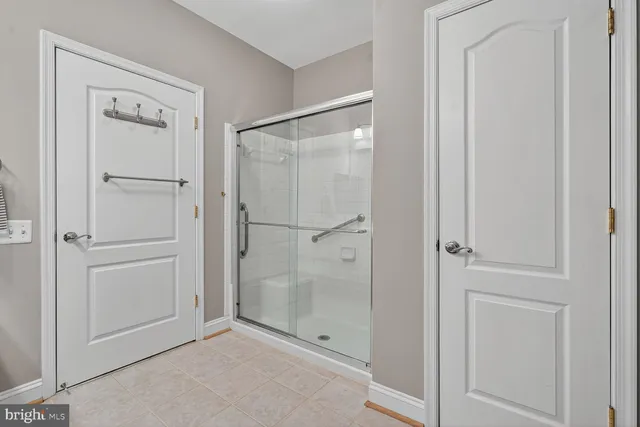 a bathroom with a shower and a glass door