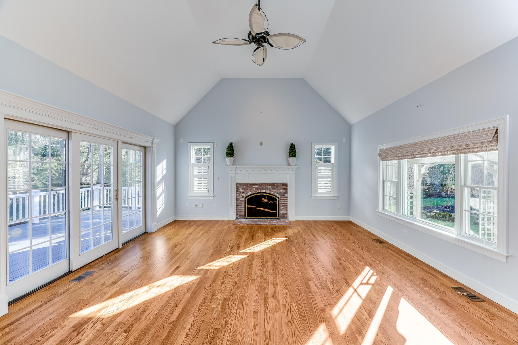 683 Mistic Drive Marstons Mills, MA 02648 - Photo 17 of 50 a view of an empty room with window a fireplace and a chandelier