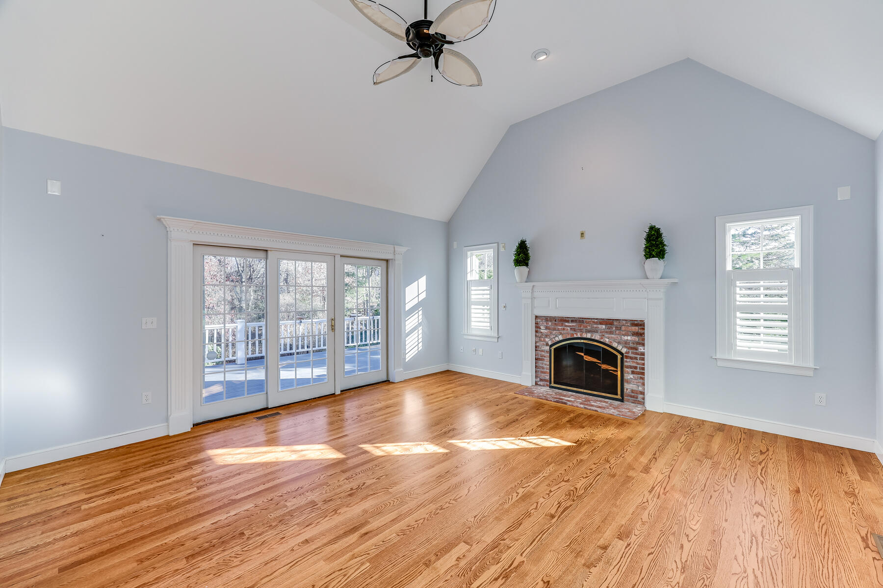 683 Mistic Drive Marstons Mills, MA 02648 - Photo 18 of 50 a view of empty room with fireplace wooden floor and windows