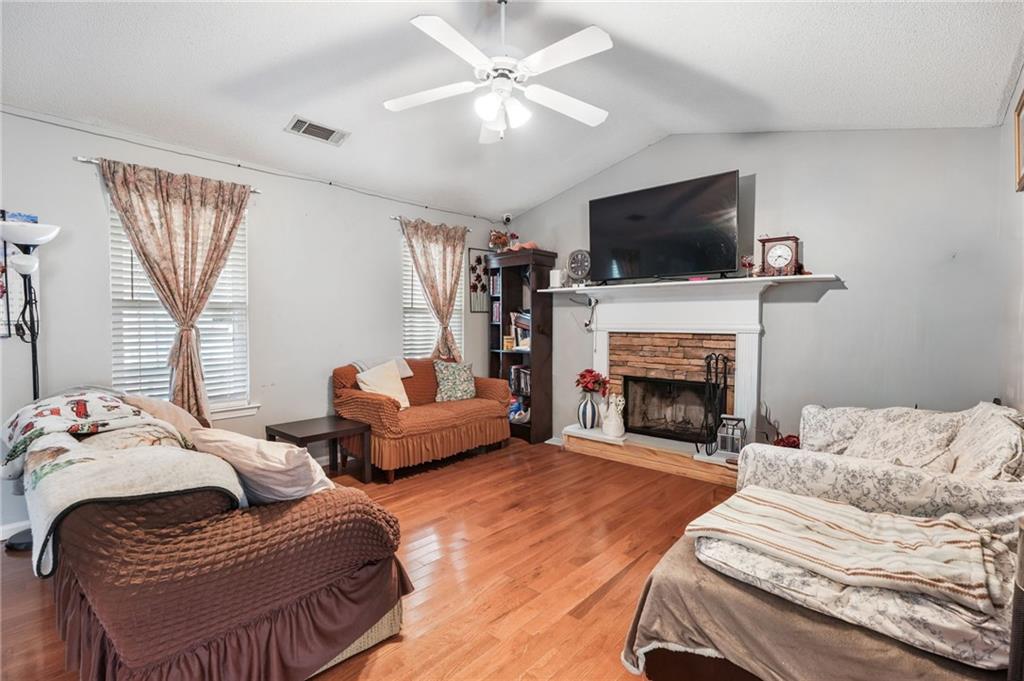 367 Benjamin Drive Rockmart, GA 30153 - Photo 6 of 34 a living room with furniture a fireplace and a flat screen tv