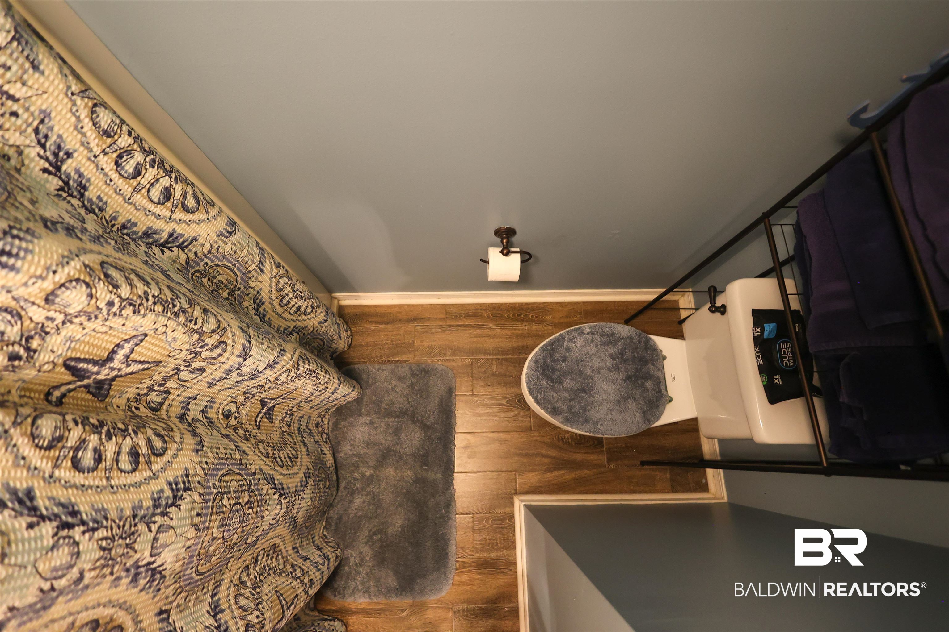7790 Audubon Drive Foley, AL 36535 - Photo 31 of 39 Bathroom featuring wood-finish flooring and light blue wall paint