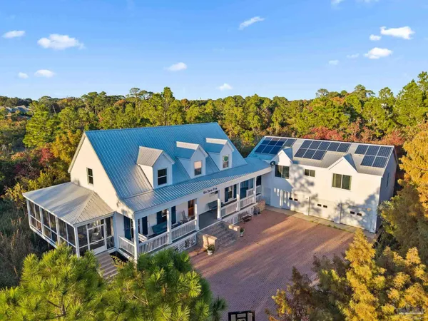 an aerial view of a house with a big yard
