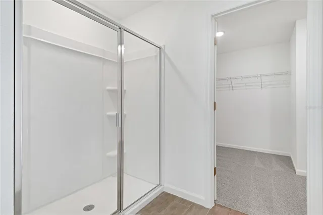 a bathroom with a glass shower door