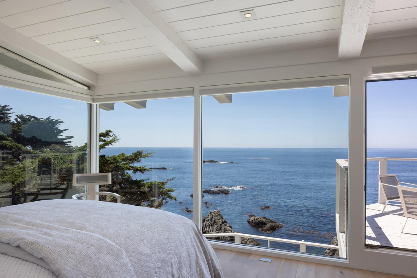 162 Spindrift Road Carmel, CA 93923 - Photo 18 of 34 a bedroom with a bed and large windows