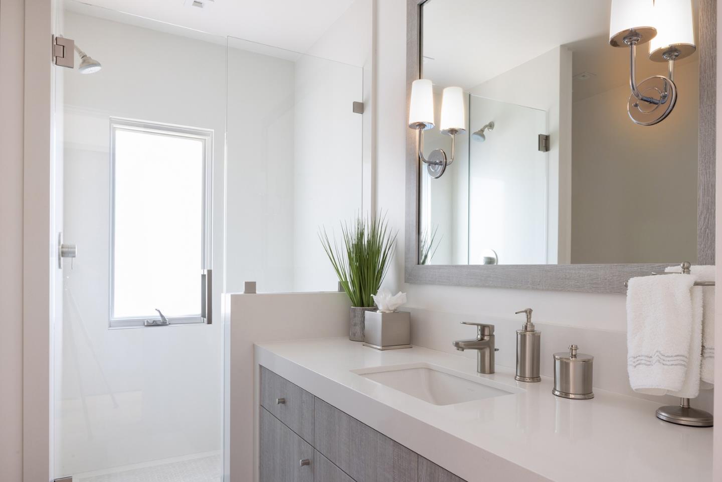 162 Spindrift Road Carmel, CA 93923 - Photo 19 of 34 a bathroom with a sink a mirror and a shower