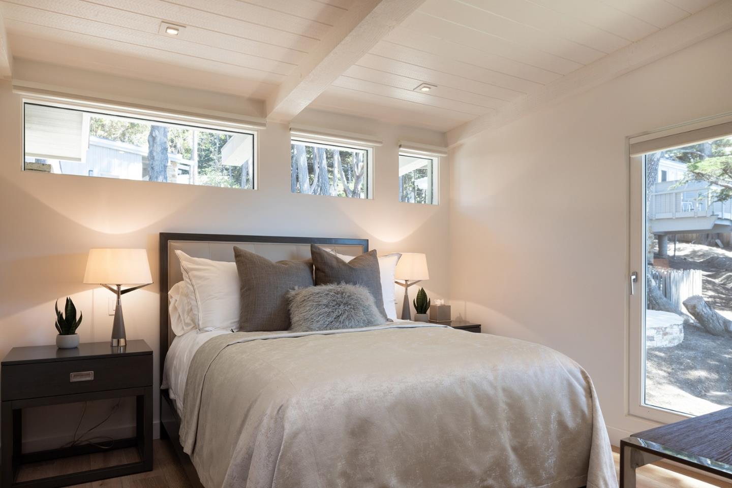 162 Spindrift Road Carmel, CA 93923 - Photo 20 of 34 a bedroom with a bed and a night stand