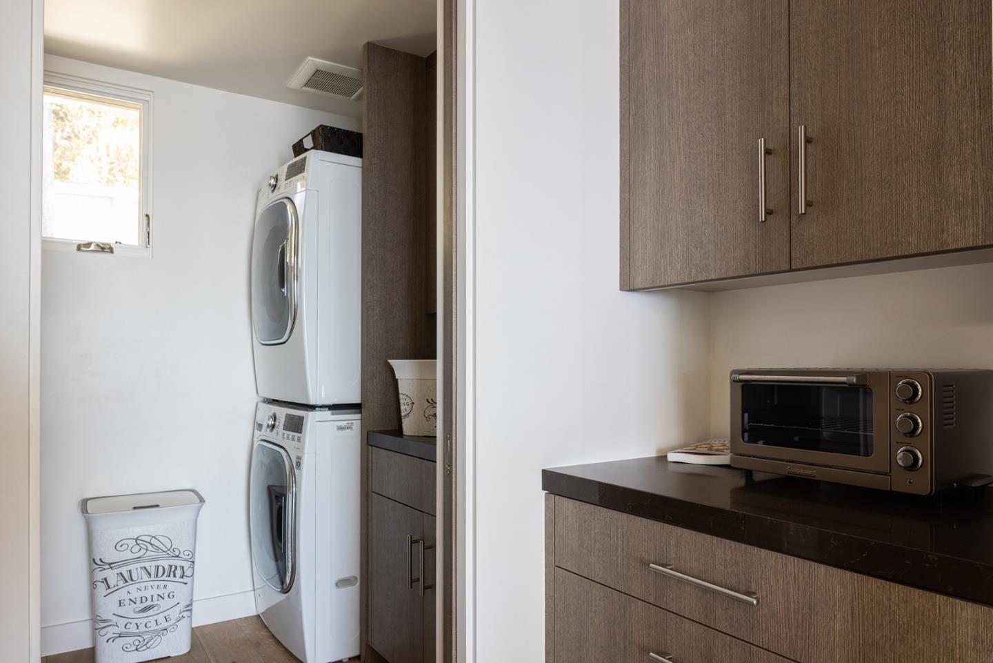 162 Spindrift Road Carmel, CA 93923 - Photo 22 of 34 a kitchen with a refrigerator and cabinets