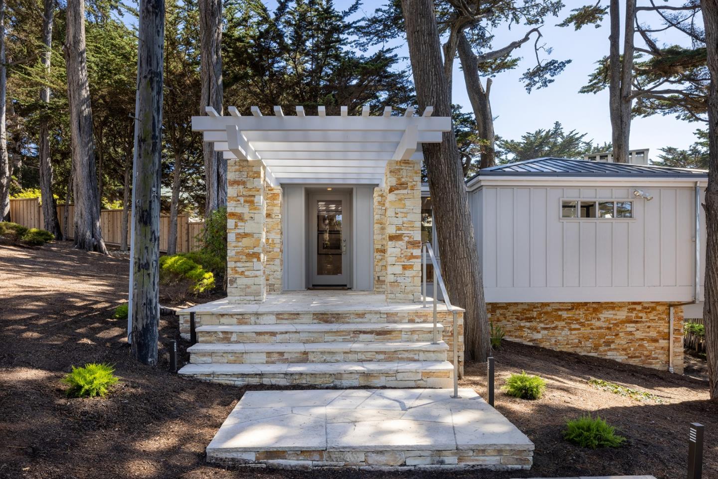 162 Spindrift Road Carmel, CA 93923 - Photo 26 of 34 a front view of a house with a yard and potted plants