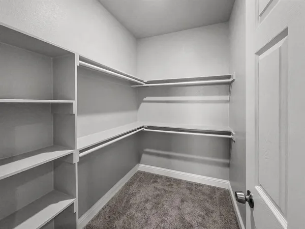 an empty room with windows and ceiling fan