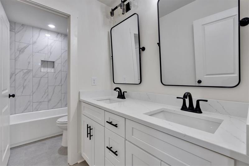 133 Old Alabama Road Southeast Emerson, GA 30137 - Photo 36 of 44 a bathroom with a double vanity sink and mirror with bathtub